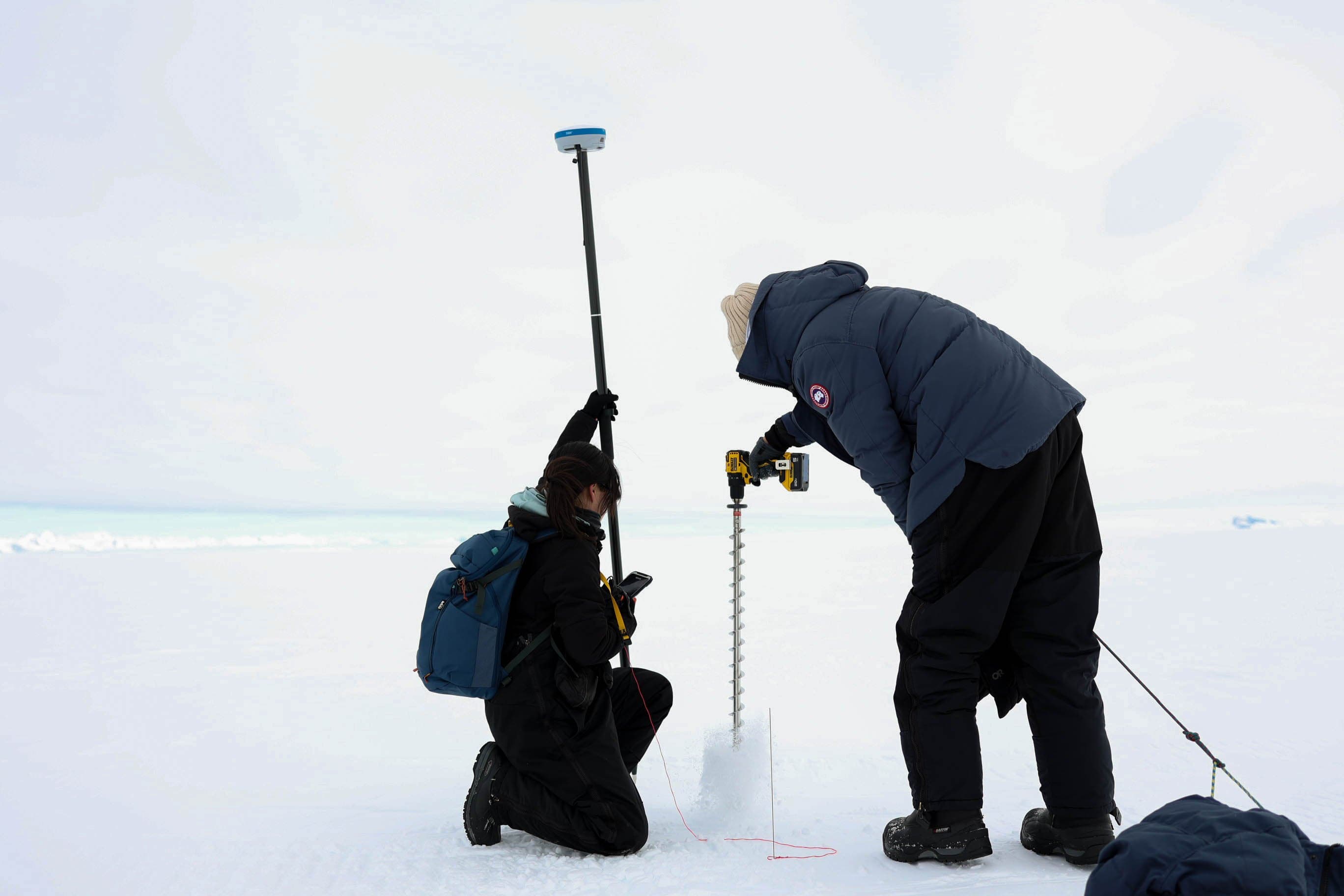 Soyeon Park and Chris Lefler install STRYDE seismic nodes in the snow.